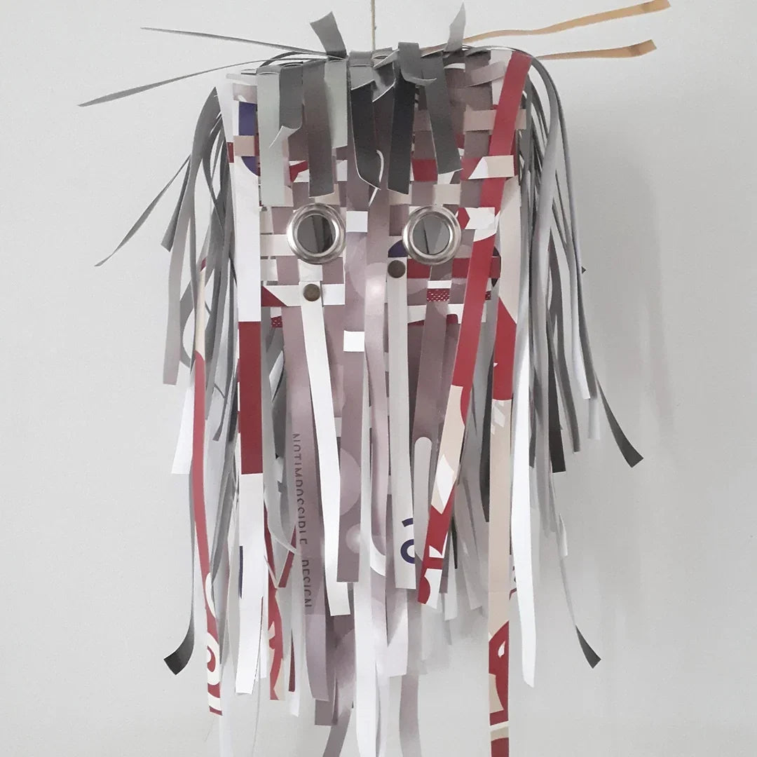 ReCreate created masks for P.Art.S. and FIMI, transforming reclaimed advertising banners into expressive objects through weaving and design.