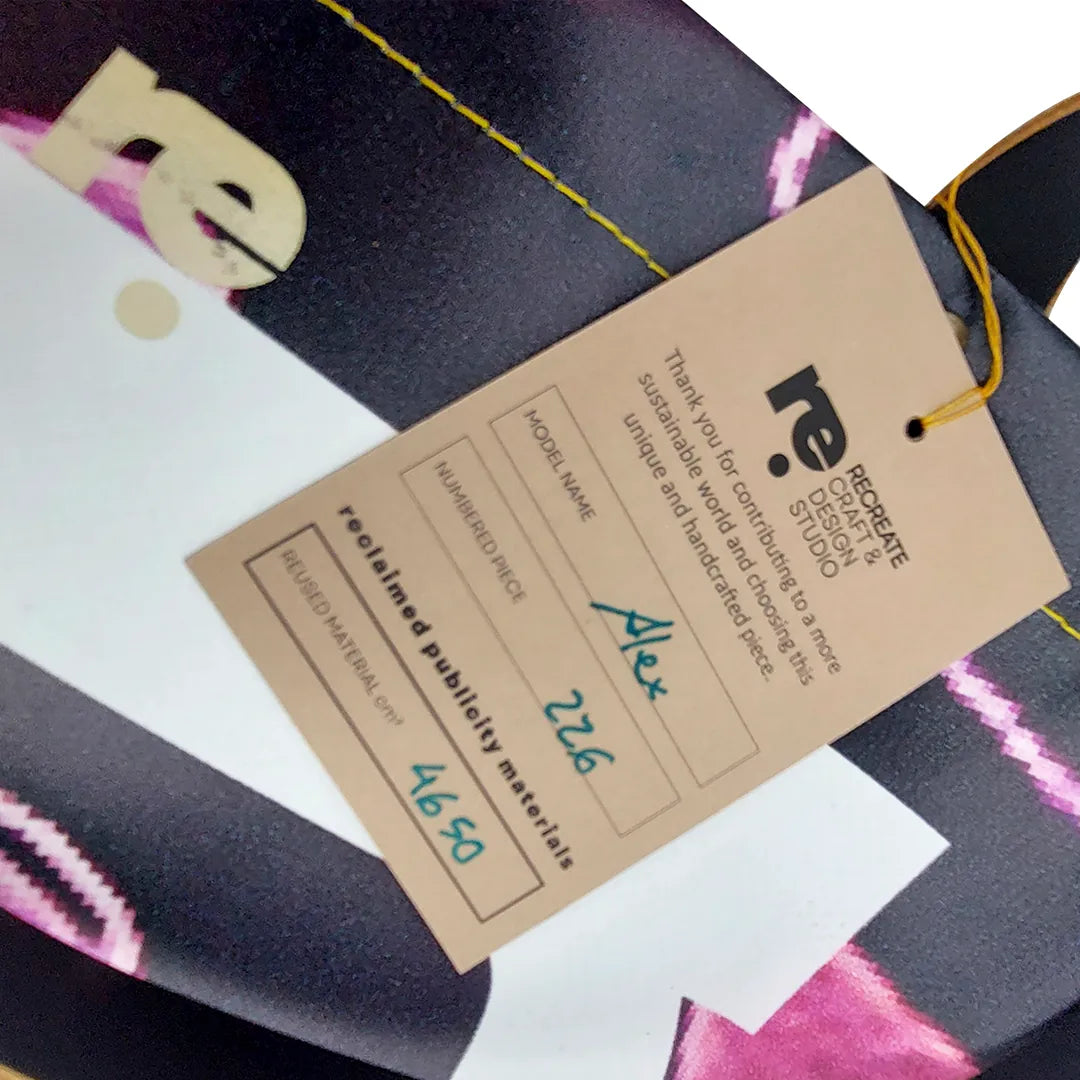 Graphic tote bag handmade from reclaimed banner material, with leather handles and an interior pocket. Unique, numbered and made in Lisbon. - tag