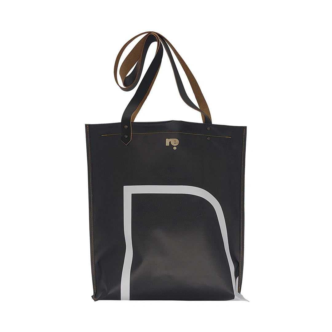 Handmade tote bag crafted from reclaimed banner material with leather handles and an interior pocket. A unique numbered piece made in Lisbon by ReCreate. - back