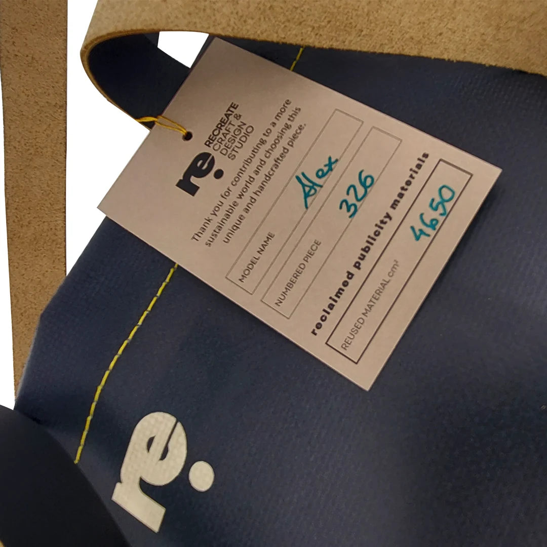 Handmade tote bag crafted from reclaimed banner material with leather handles and an interior pocket. A unique numbered piece made in Lisbon by ReCreate. - tag