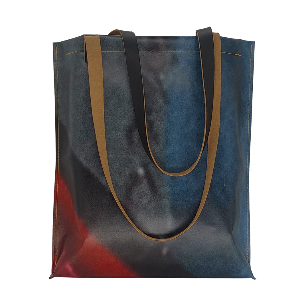 Unique handmade bag made from reclaimed advertising banner, with leather handles and an interior pocket. A numbered ReCreate piece crafted in Lisbon. - front