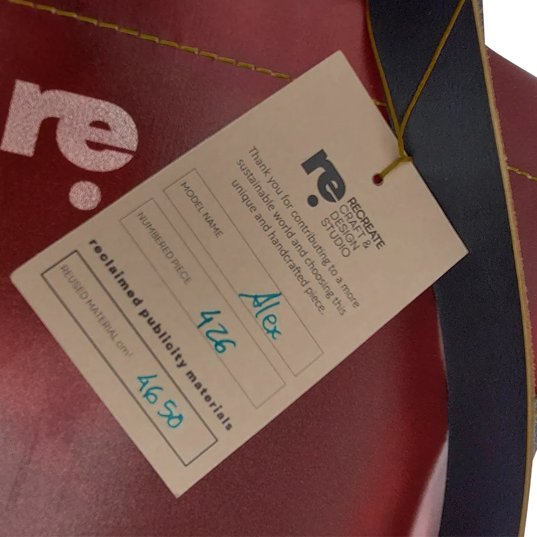 Unique handmade bag made from reclaimed advertising banner, with leather handles and an interior pocket. A numbered ReCreate piece crafted in Lisbon. - tag