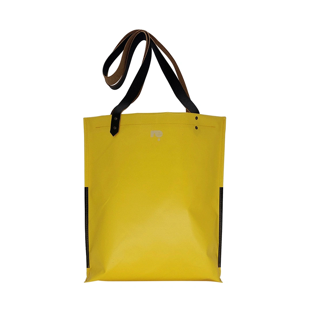 One-of-a-kind yellow and black handmade bag in reclaimed advertising banner, with leather handles and an inside pocket. Numbered ReCreate piece. - back