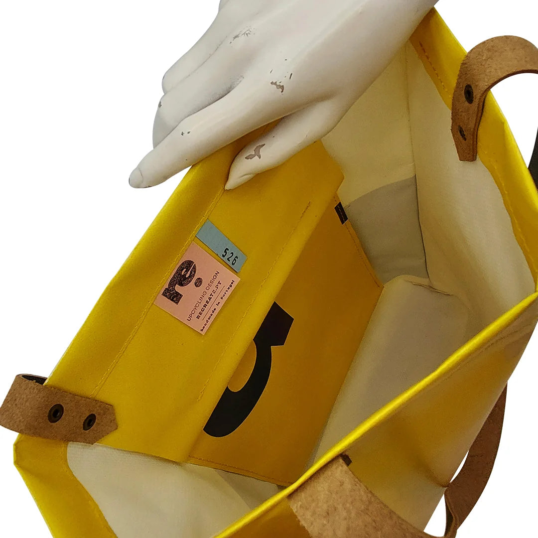 One-of-a-kind yellow and black handmade bag in reclaimed advertising banner, with leather handles and an inside pocket. Numbered ReCreate piece. - pocket