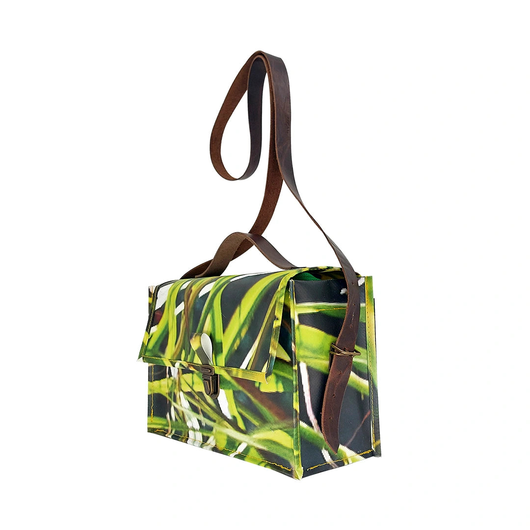 Alice Bag 126 by ReCreate, a structured bag in reclaimed advertising banner with green graphic movement and leather strap. - side