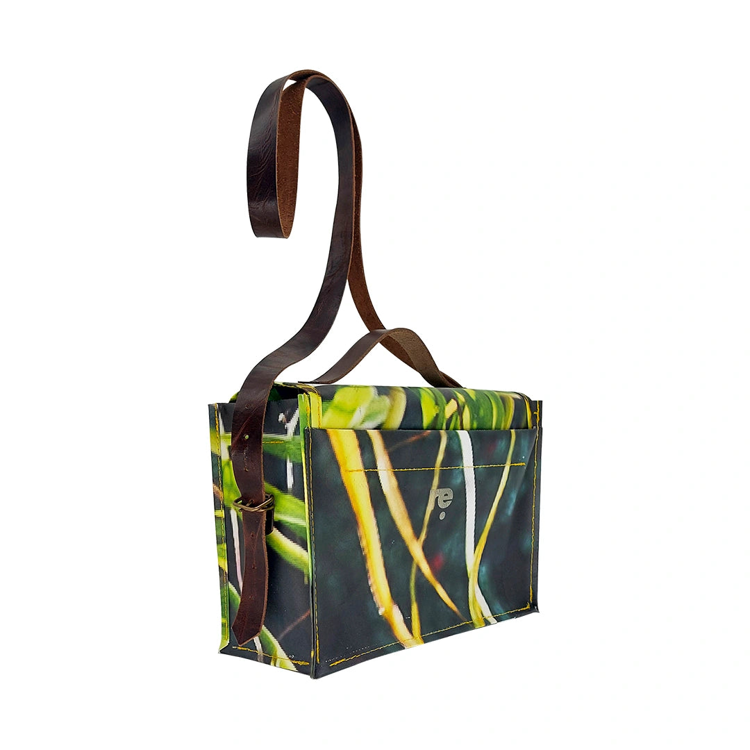 Alice Bag 126 by ReCreate, a structured bag in reclaimed advertising banner with green graphic movement and leather strap. - side