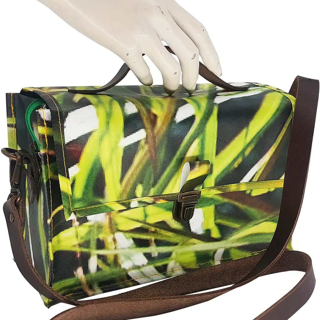 Alice Bag 126 by ReCreate, a structured bag in reclaimed advertising banner with green graphic movement and leather strap. - detail