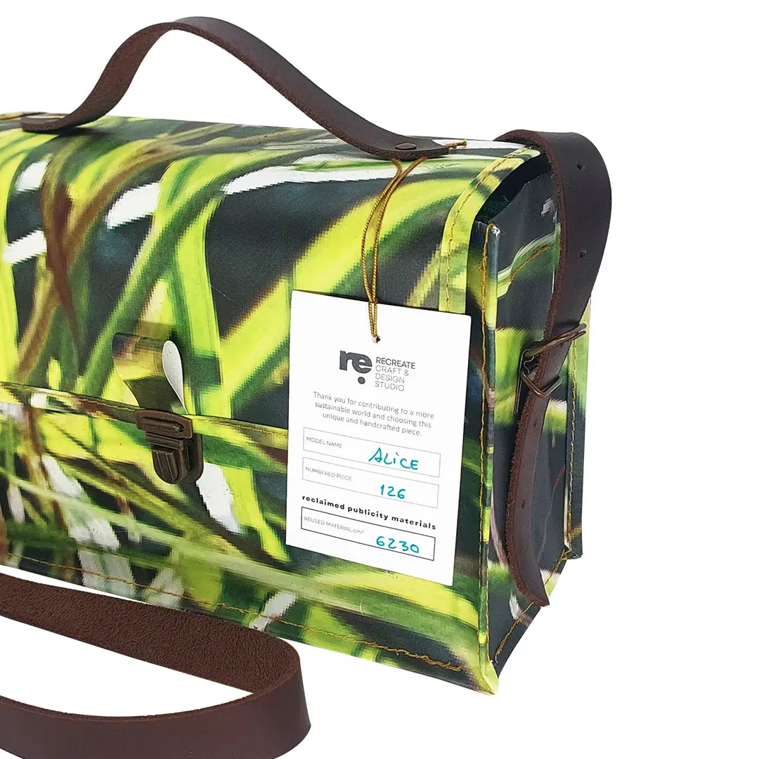 Alice Bag 126 by ReCreate, a structured bag in reclaimed advertising banner with green graphic movement and leather strap. - tag