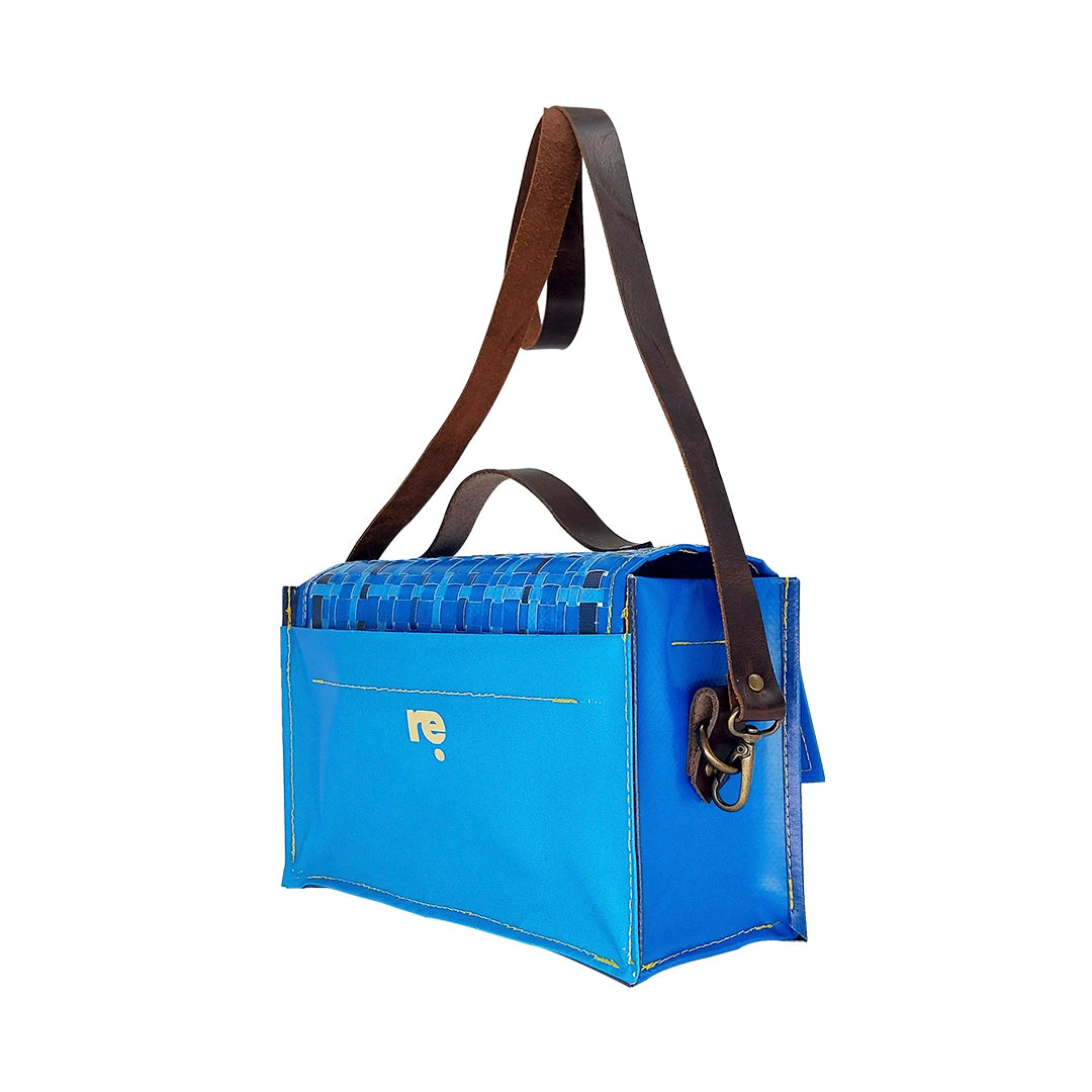 Alice Special Edition Bag 126 by ReCreate, a blue structured bag in reclaimed advertising banner with woven flap and leather strap. - side