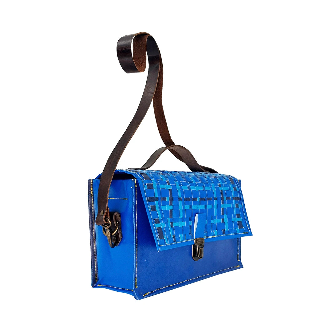 Alice Special Edition Bag 126 by ReCreate, a blue structured bag in reclaimed advertising banner with woven flap and leather strap. -side