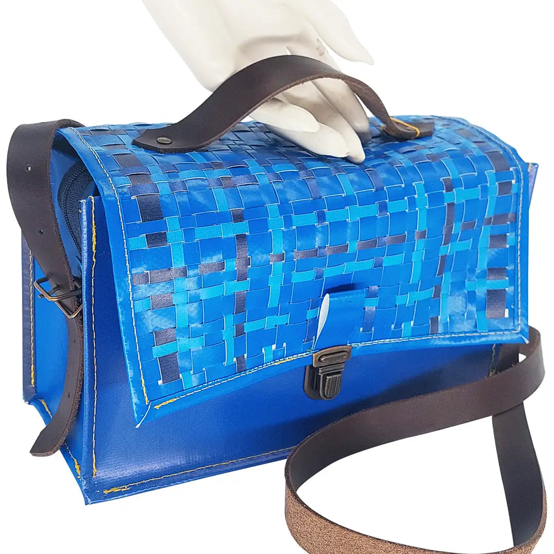 Alice Special Edition Bag 126 by ReCreate, a blue structured bag in reclaimed advertising banner with woven flap and leather strap. - detail
