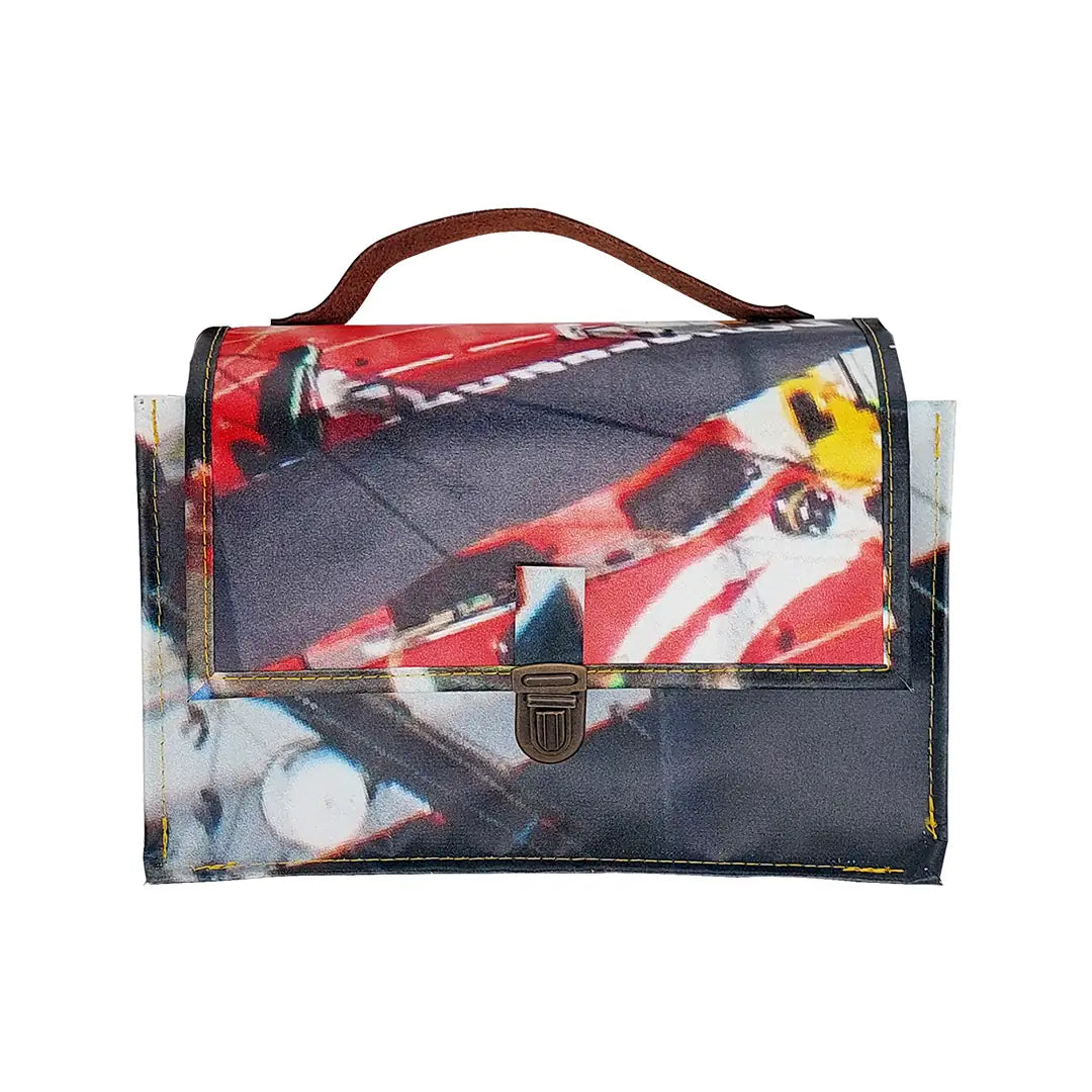 Alice Bag 224 by ReCreate, a structured bag in reclaimed advertising banner with red graphic fragments, leather strap and yellow zip. -front