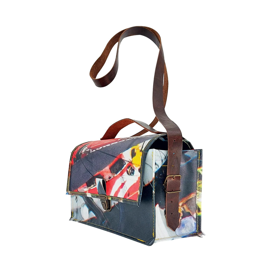 Alice Bag 224 by ReCreate, a structured bag in reclaimed advertising banner with red graphic fragments, leather strap and yellow zip. - side
