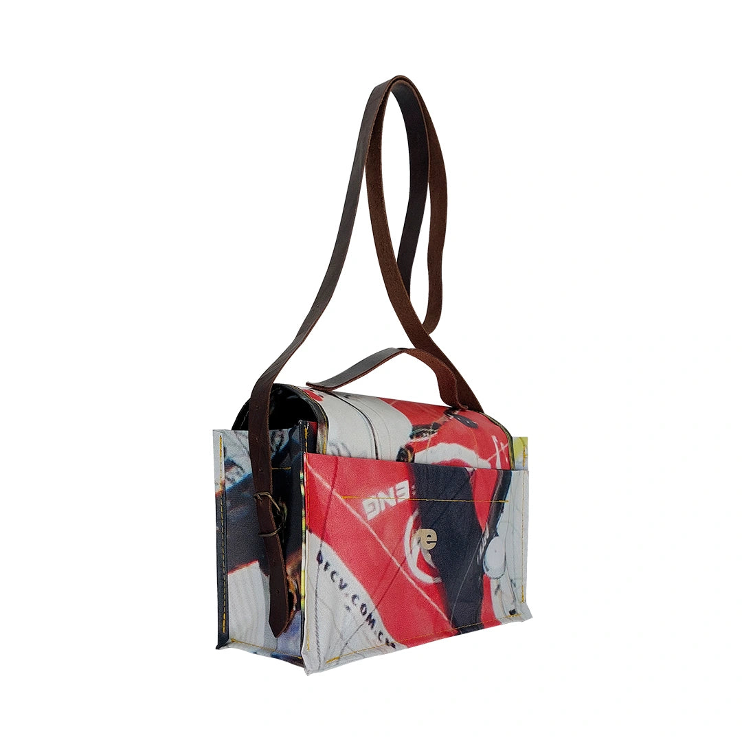Alice Bag 224 by ReCreate, a structured bag in reclaimed advertising banner with red graphic fragments, leather strap and yellow zip. -side