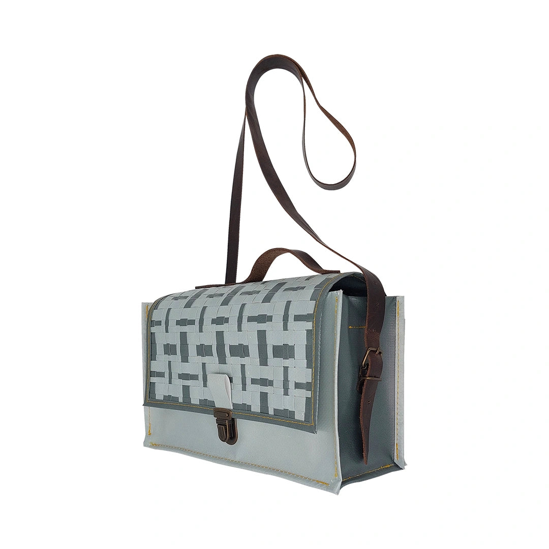 Alice Special Edition Bag 224 by ReCreate, a grey special edition bag in reclaimed advertising banner with woven flap and leather strap. - side