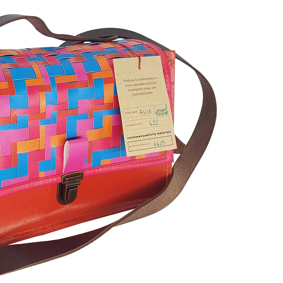 Alice Special Edition Bag 625 by ReCreate, a vibrant special edition bag in reclaimed advertising banner with woven flap and leather strap. - tag