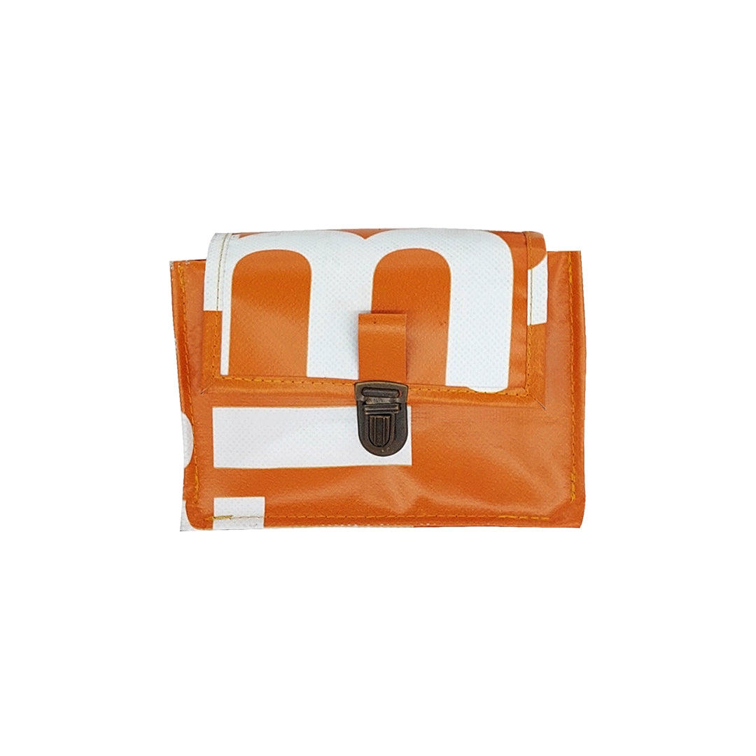 Anita Bag 424 by ReCreate, a compact orange bag in reclaimed advertising banner with bold white graphics, leather strap and metal clasp. - front