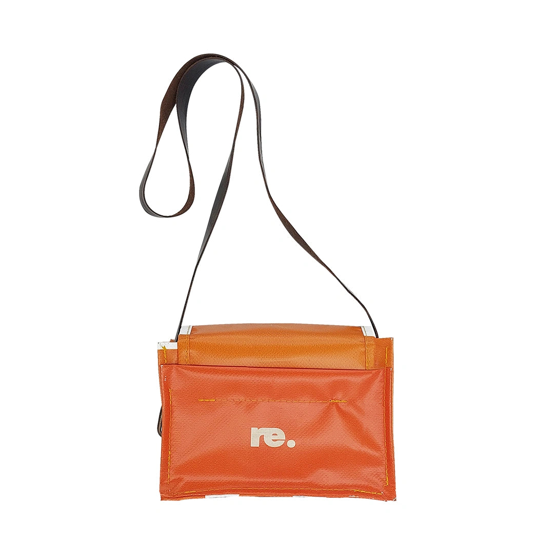 Anita Bag 424 by ReCreate, a compact orange bag in reclaimed advertising banner with bold white graphics, leather strap and metal clasp. - back