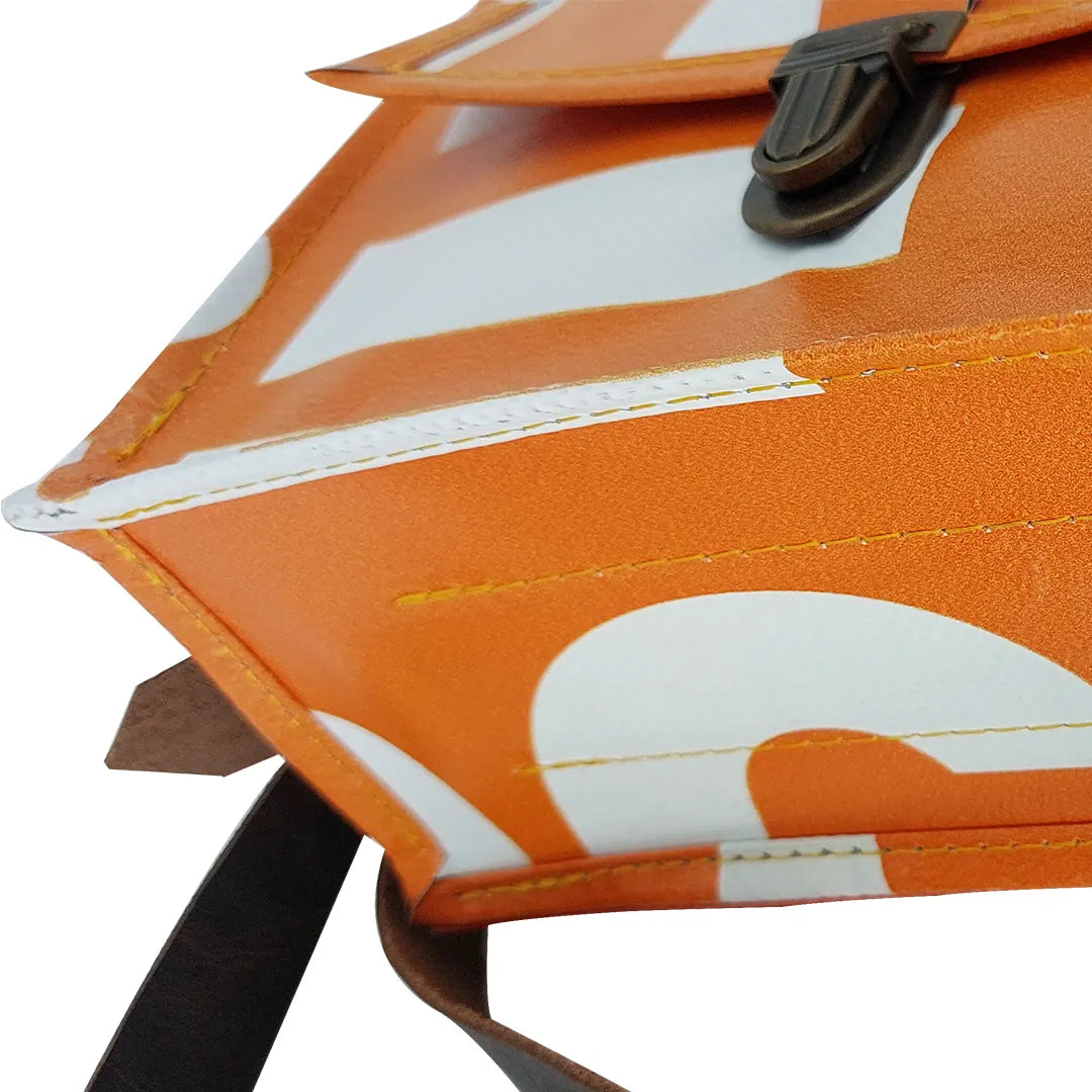 Anita Bag 424 by ReCreate, a compact orange bag in reclaimed advertising banner with bold white graphics, leather strap and metal clasp. - bottom