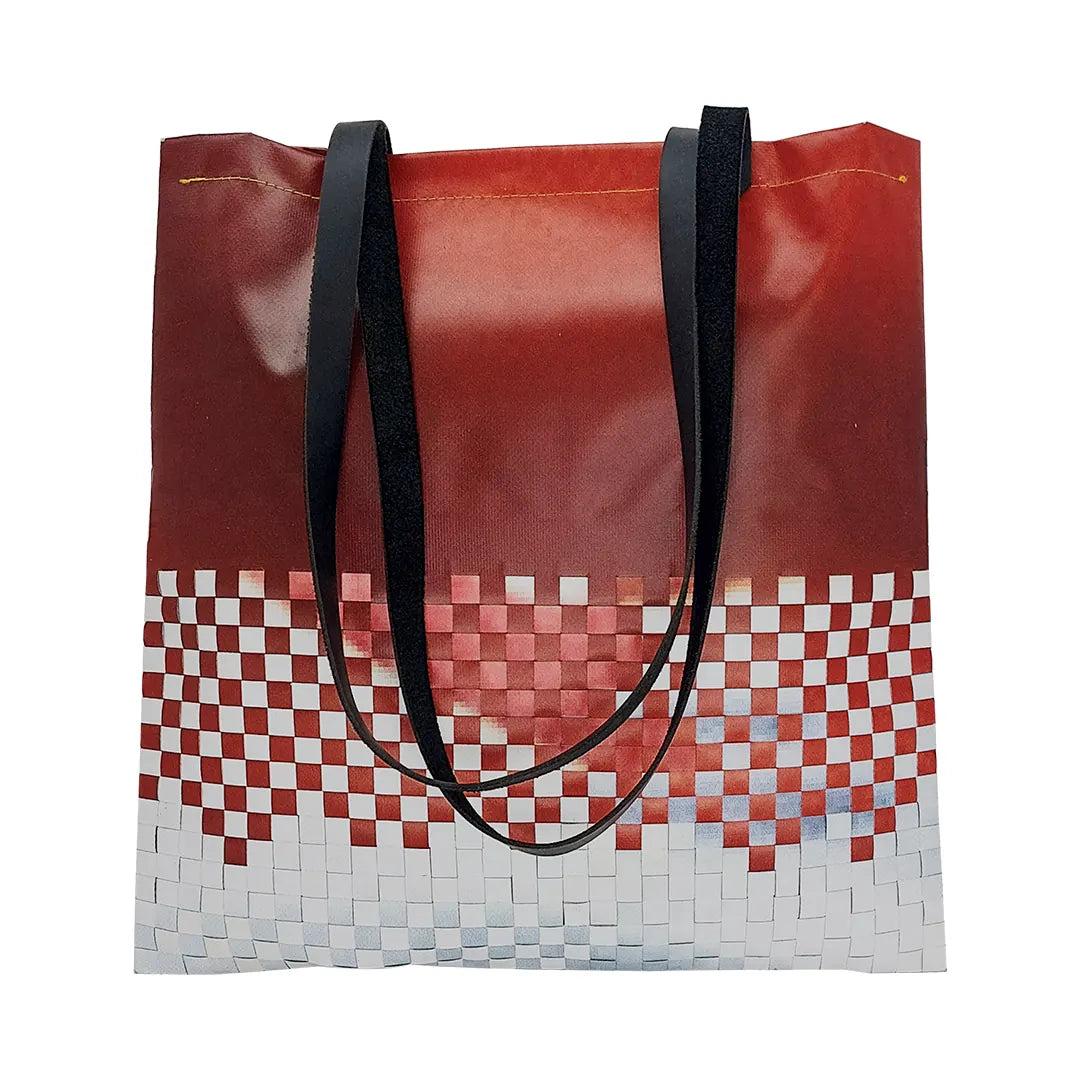 Inversa Bag 223 by ReCreate, a red and white tote in reclaimed advertising banner with inverted woven work, leather straps and one inner pocket. - front
