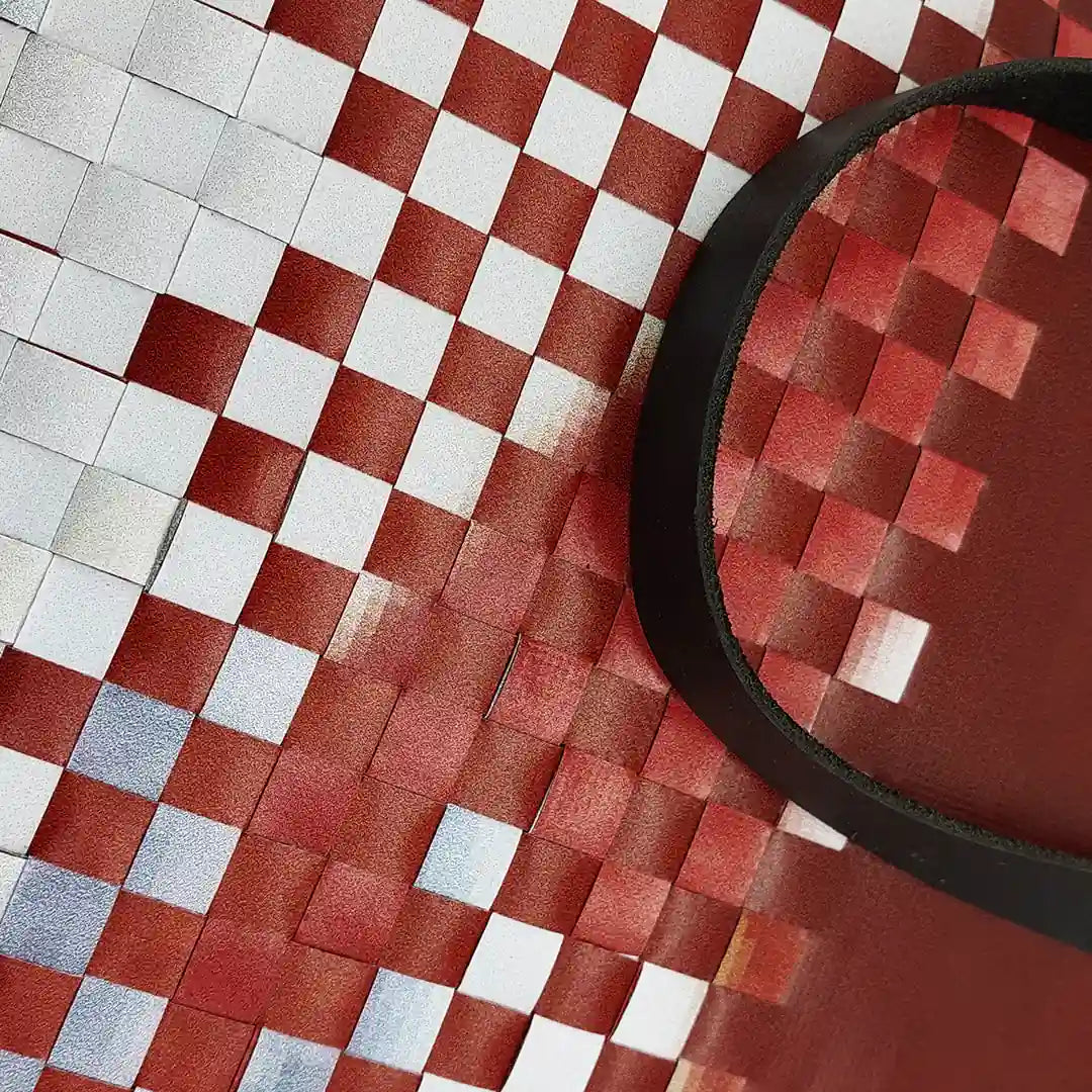 Inversa Bag 223 by ReCreate, a red and white tote in reclaimed advertising banner with inverted woven work, leather straps and one inner pocket. - detail