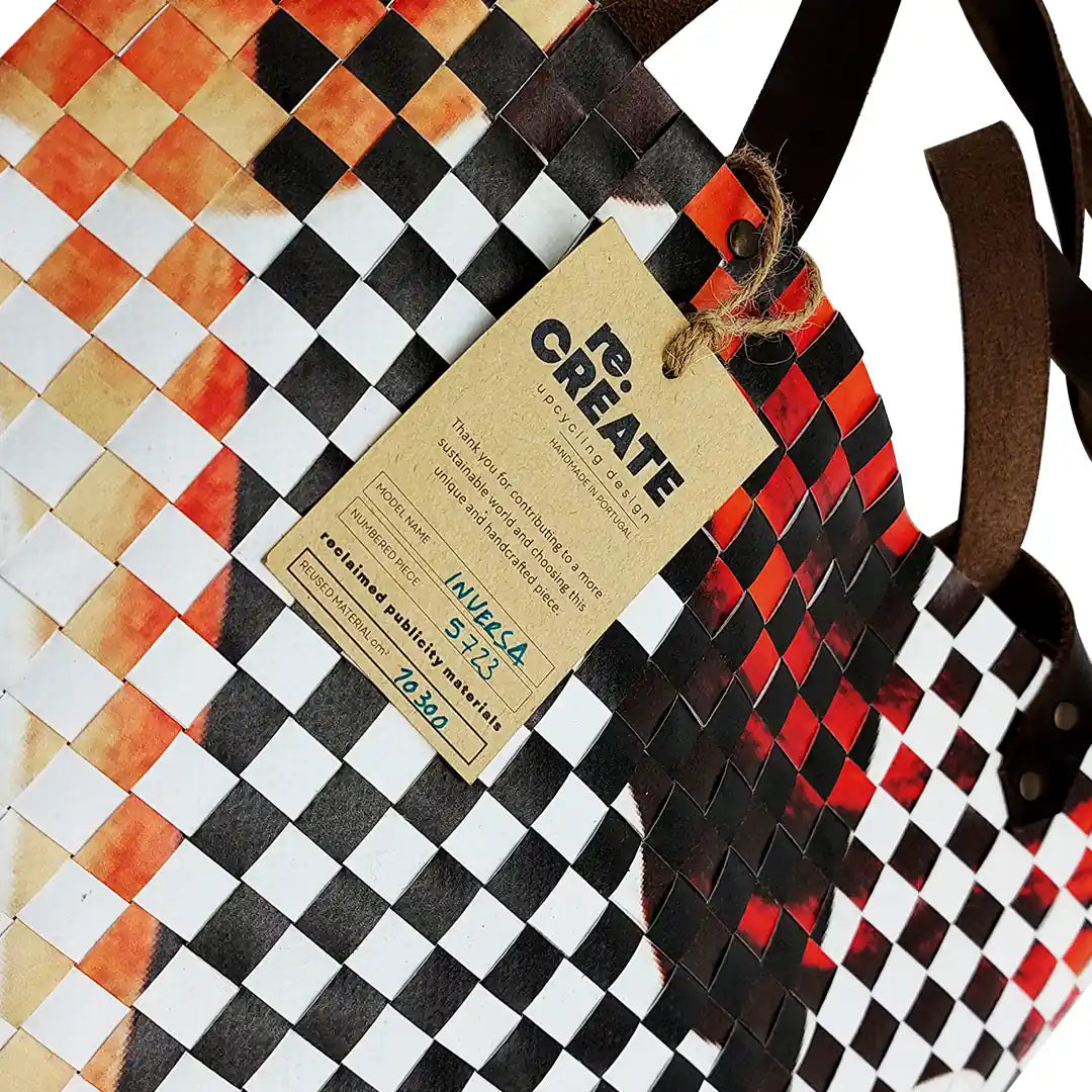 Inversa Bag 5723 by ReCreate, a graphic tote in reclaimed advertising banner with inverted weaving, leather straps and one inner pocket. - tag