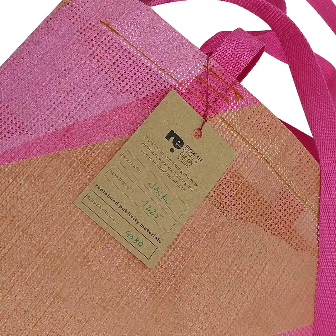 Jack Tote Bag 1225 by ReCreate, made from micro-perforated reclaimed banner with pink handles, two inner pockets and dual carry. - tag