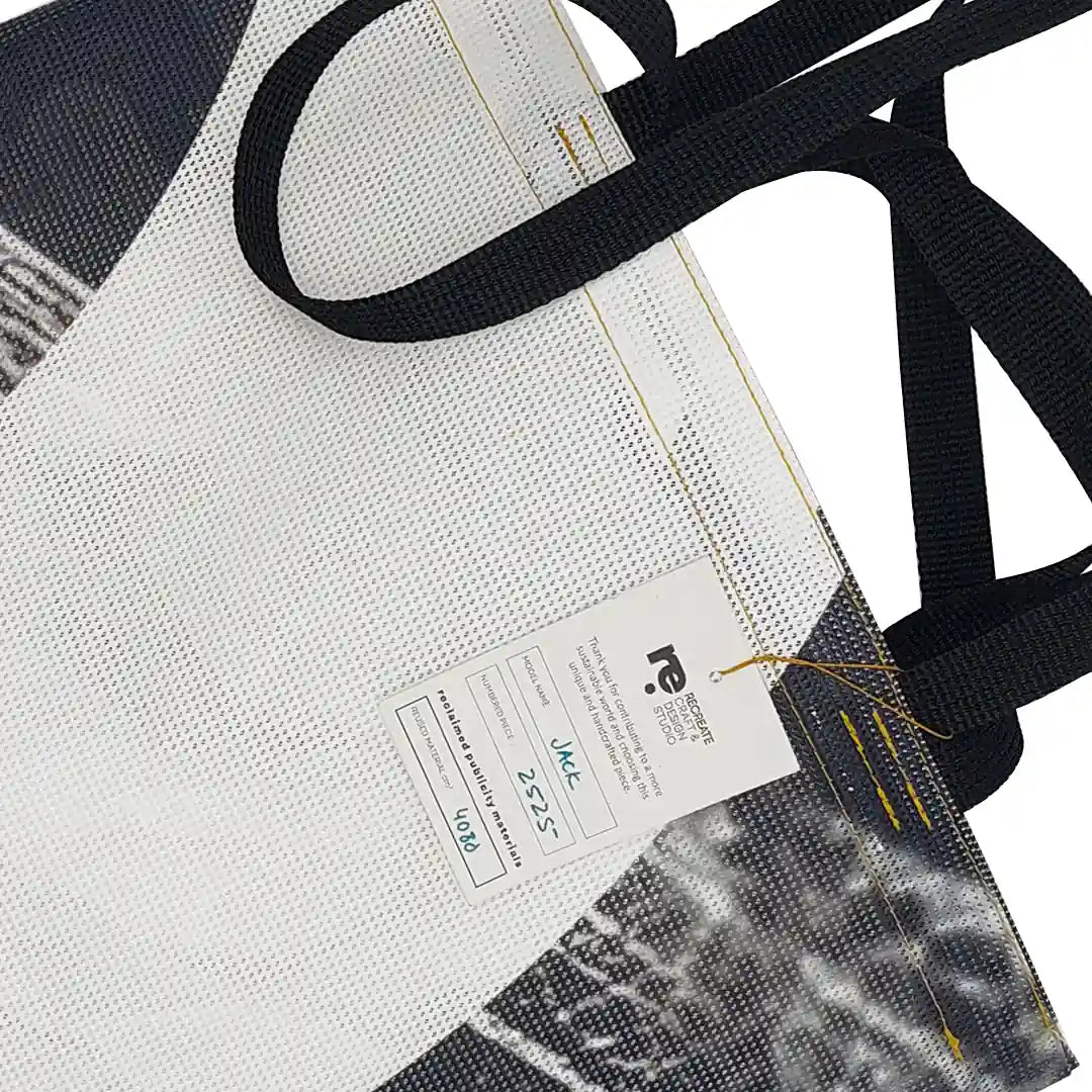 Jack Tote Bag 2525 by ReCreate, made from micro-perforated reclaimed banner with purple straps, two inner pockets and dual carry. - tag