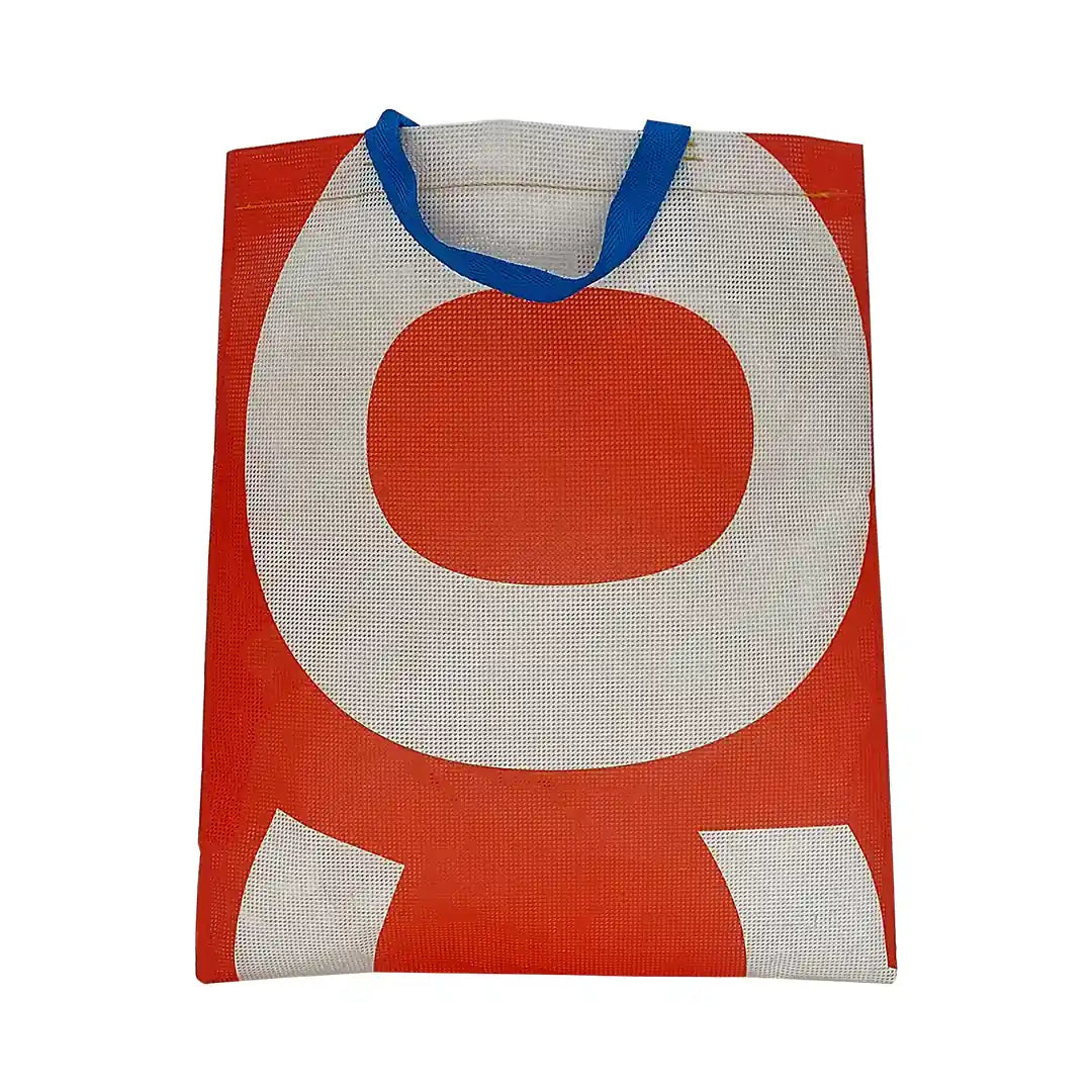 Red and white tote made from reclaimed advertising mesh banner, with blue handles and bold graphic curves from the original print. - front