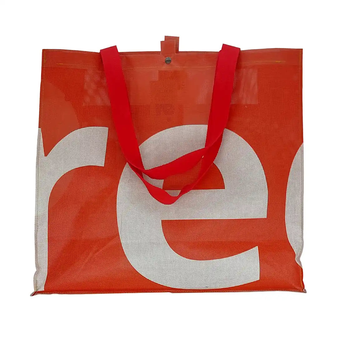 Júlia Bag 224 by ReCreate, a large red tote made from micro-perforated reclaimed banner with five inner pockets and snap closures. - front