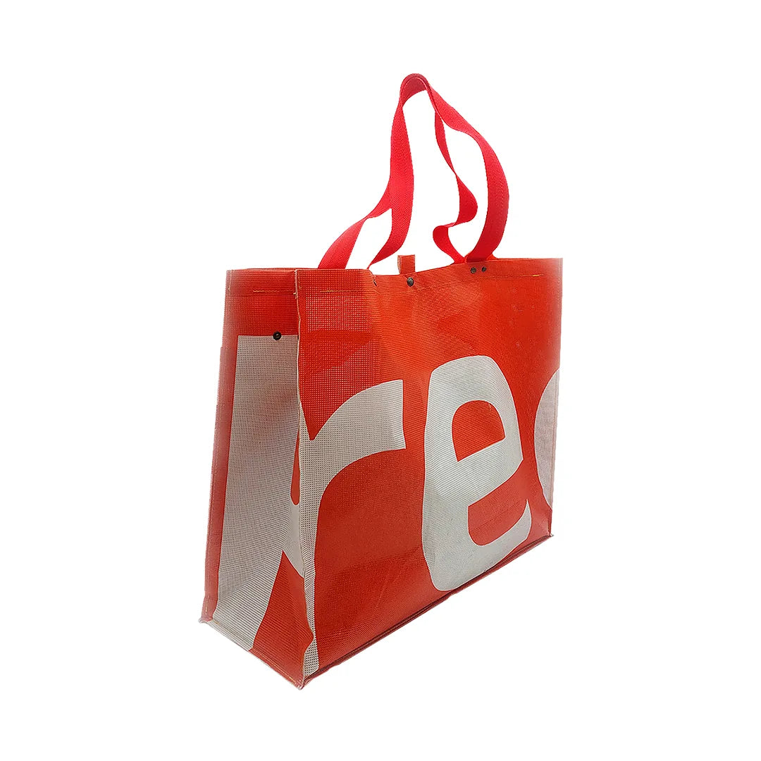 Júlia Bag 224 by ReCreate, a large red tote made from micro-perforated reclaimed banner with five inner pockets and snap closures. - side