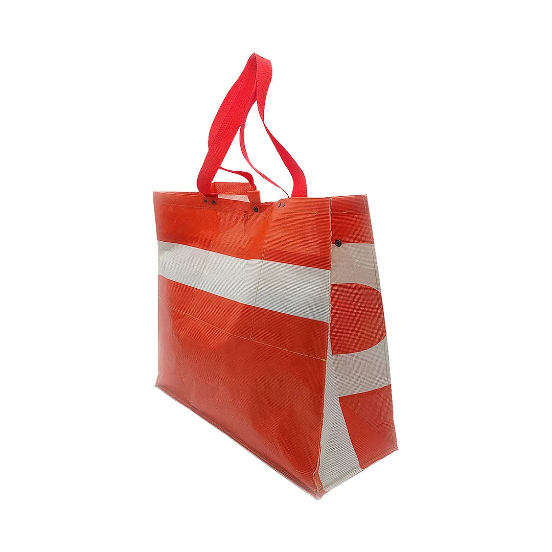 Júlia Bag 224 by ReCreate, a large red tote made from micro-perforated reclaimed banner with five inner pockets and snap closures. - side