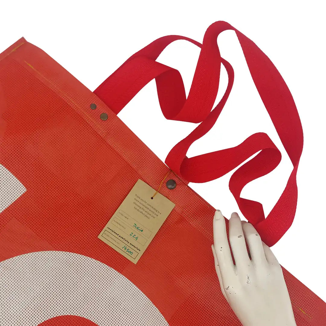 Júlia Bag 224 by ReCreate, a large red tote made from micro-perforated reclaimed banner with five inner pockets and snap closures. - tag