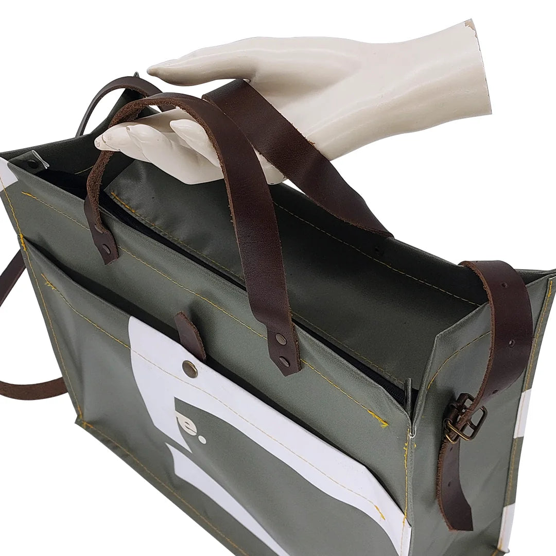 Julieta Bag 224 Special Edition by ReCreate, a structured green bag in reclaimed advertising banner with leather straps and graphic weaving- handle