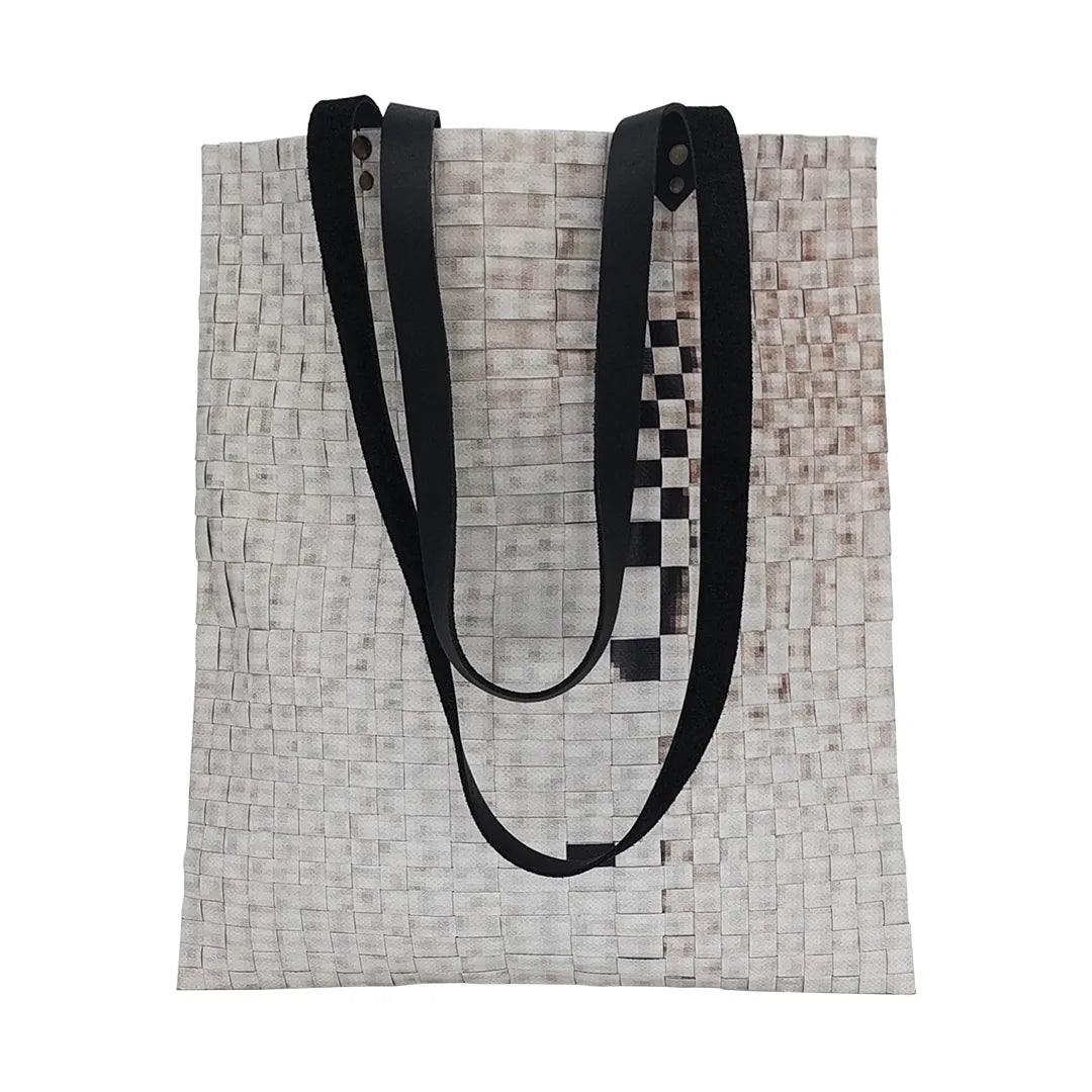 Rita Bag 1623 by ReCreate, a pale woven tote in reclaimed advertising banner with black leather straps and one inner pocket. - front
