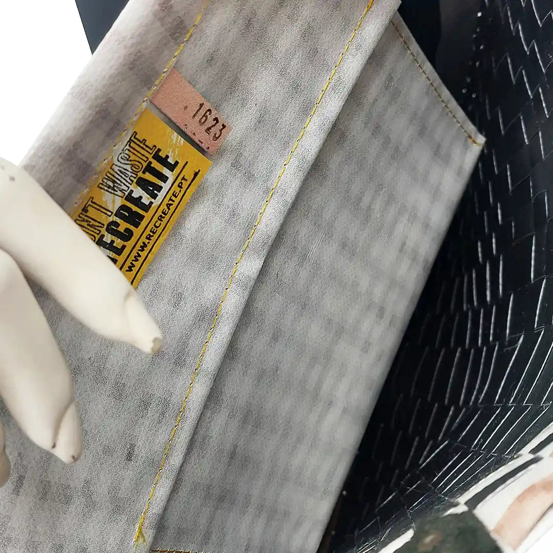Rita Bag 1623 by ReCreate, a pale woven tote in reclaimed advertising banner with black leather straps and one inner pocket. - pocket