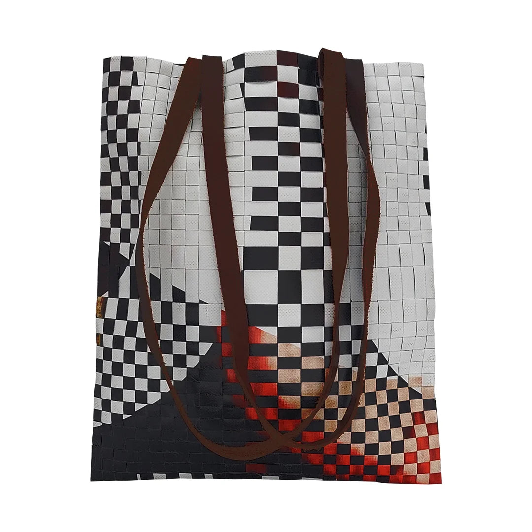 Rita Bag 523 by ReCreate, a black, white and red tote made from reclaimed advertising banner with leather straps and one inner pocket. - front