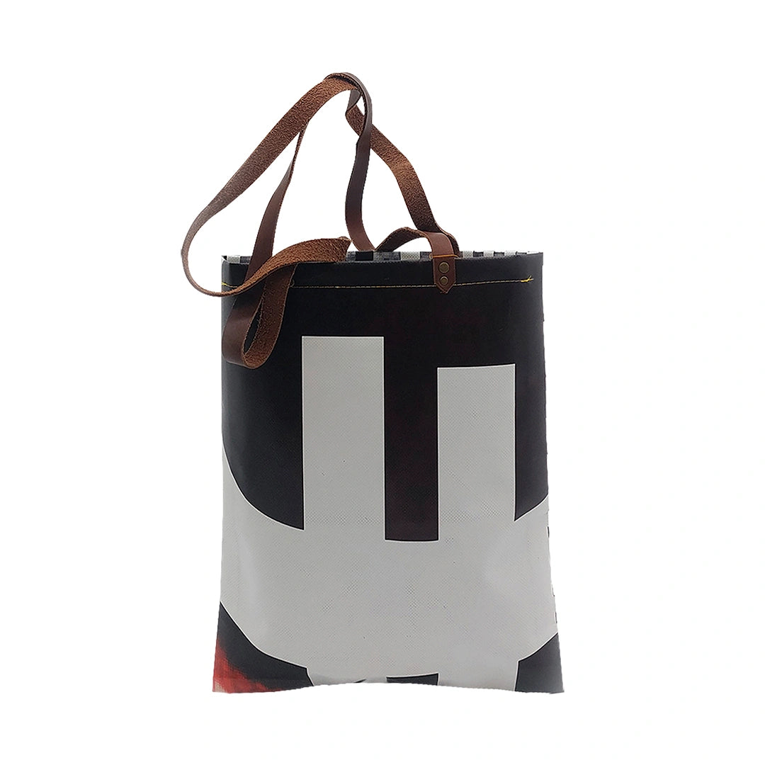 Rita Bag 523 by ReCreate, a black, white and red tote made from reclaimed advertising banner with leather straps and one inner pocket. - back