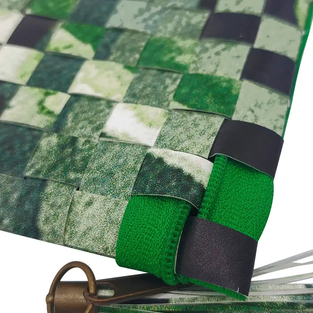Green pouch made from reclaimed advertising banner, with woven texture, graphic fragments and a zip closure. A unique object by ReCreate. - detail