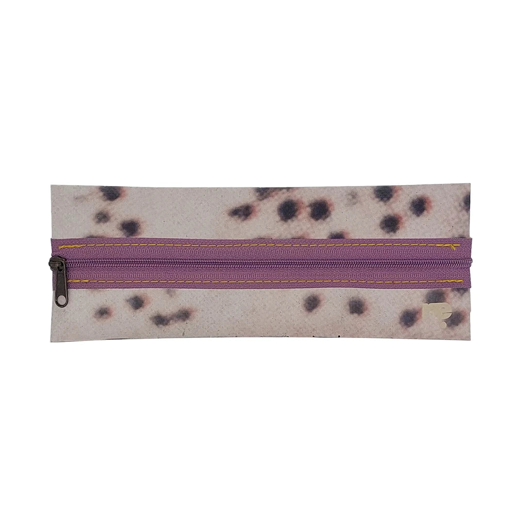 Slim one-of-a-kind pouch made from reused advertising material, with a dusty purple zip and handwoven back detail. - front