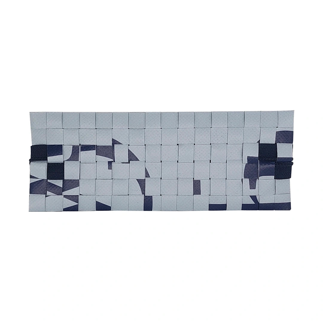Slim pouch made from reclaimed advertising banner in soft blue and navy tones, ideal for pens, cables and everyday essentials. - back