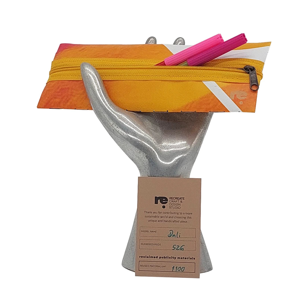 Compact banner pouch in yellow, orange and pink tones, made for pens, cables and small everyday items with a distinctive woven reverse. - with pens