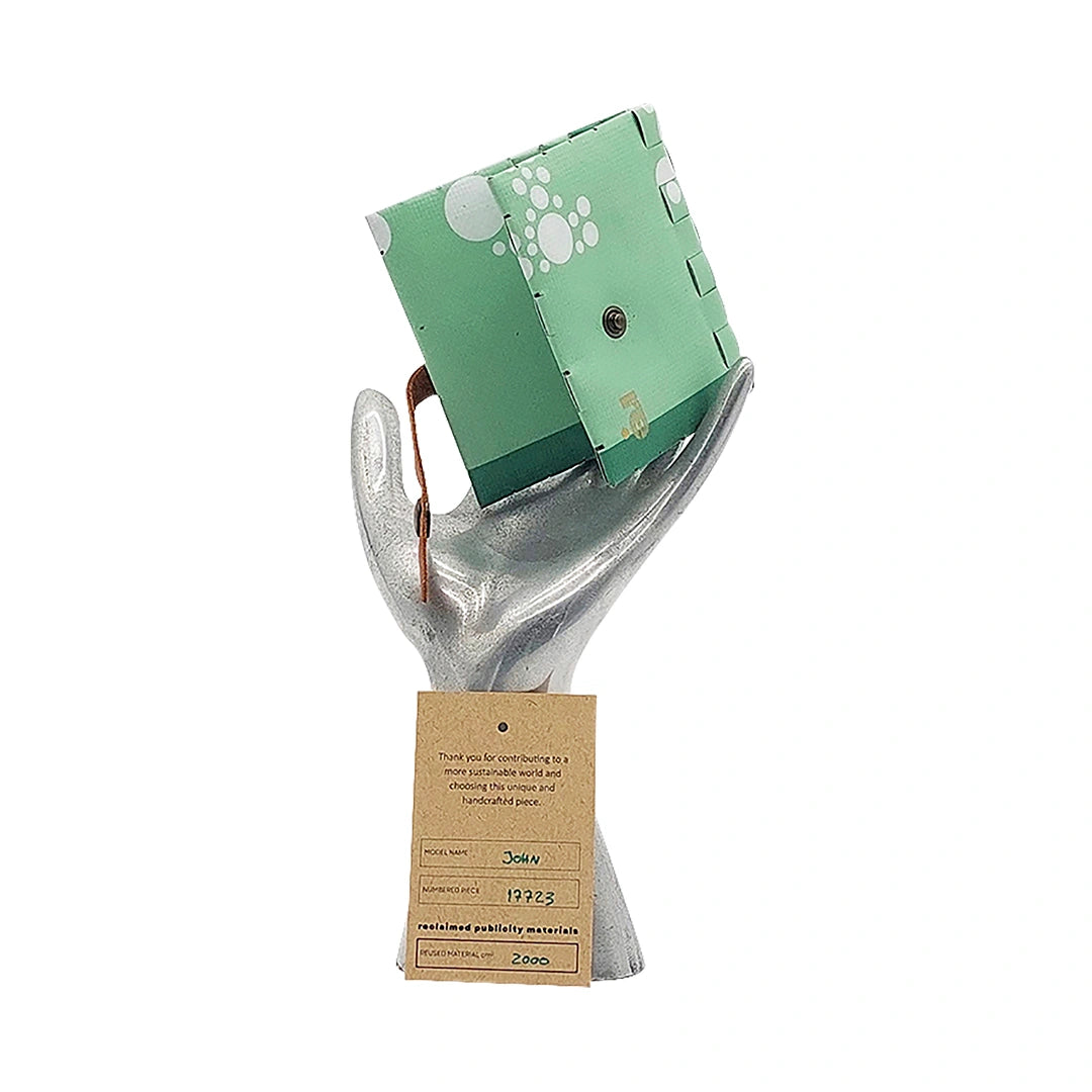 John Wallet 17723 by ReCreate is a mint-green reclaimed-banner wallet with white graphic circles, made to hold up to 8 cards and coins. - on hand