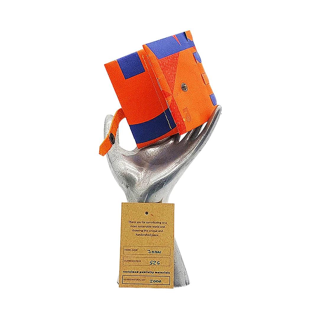 John Wallet 525 is a ReCreate wallet made from reclaimed advertising banner, with vivid orange-blue graphics, coin space and room for 8 cards. - on hand