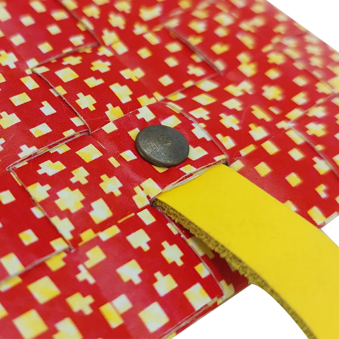 Peter Wallet 2125 by ReCreate is a red reclaimed-banner wallet with yellow graphic detail, designed to hold up to 6 cards and coins. - detail
