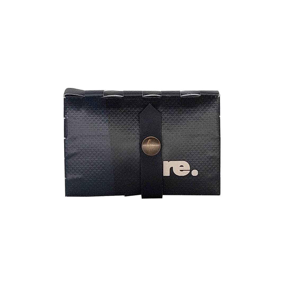 Peter Wallet 6524 by ReCreate is a compact black wallet in reclaimed advertising banner, with space for up to 6 cards and coins. - front