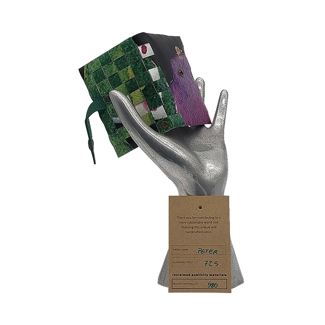 Peter Wallet 725 is a ReCreate wallet made from reclaimed advertising banner, with woven green details, coin space and room for up to 6 cards. - on hand
