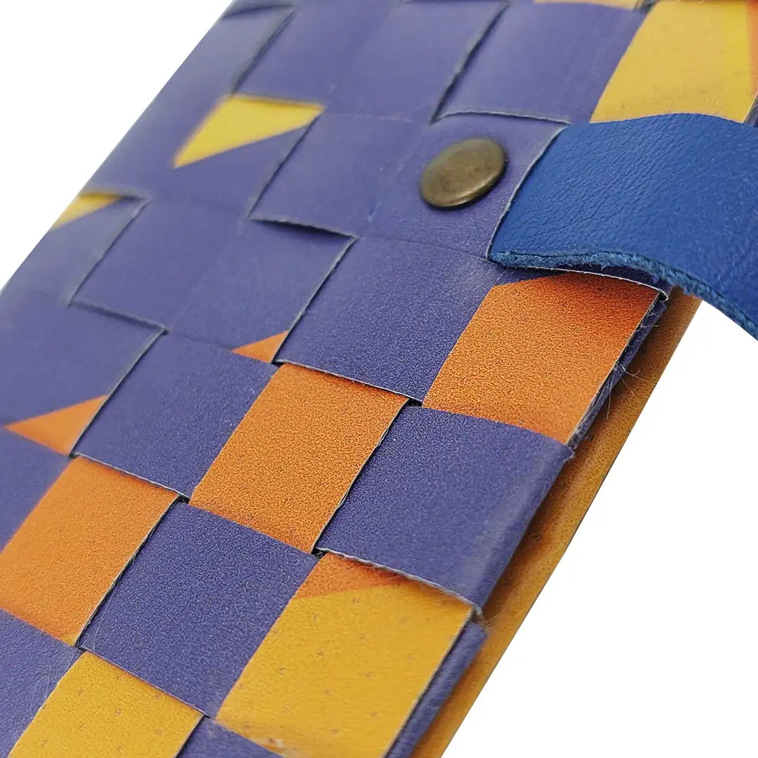 Sam Wallet 126 is a compact ReCreate wallet made from reclaimed advertising banner, with orange, violet and blue graphics and woven detail. - detail