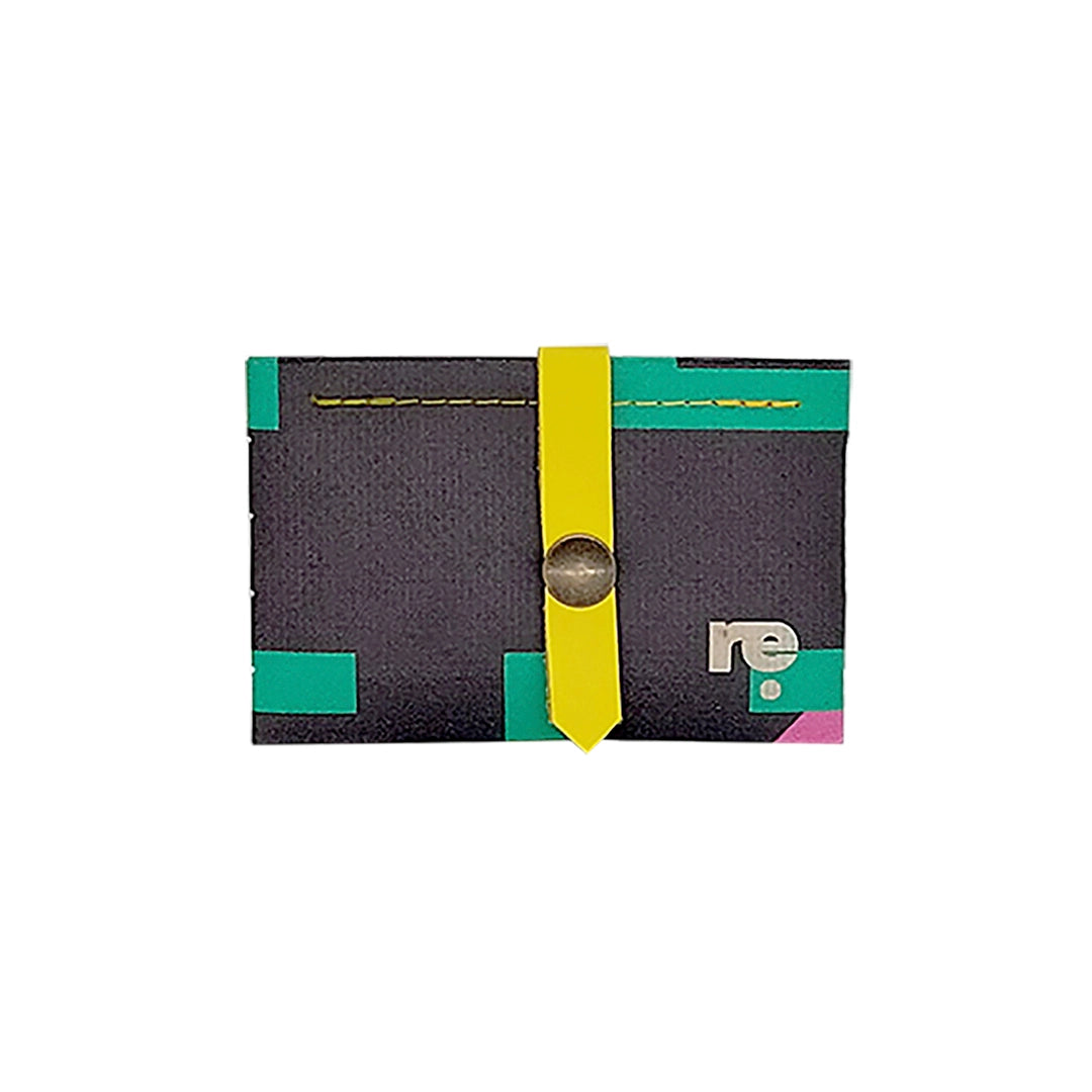 Sam Wallet 725 is a compact ReCreate wallet made from reclaimed advertising banner, with dark tones, vivid colour blocks and woven detail. - front