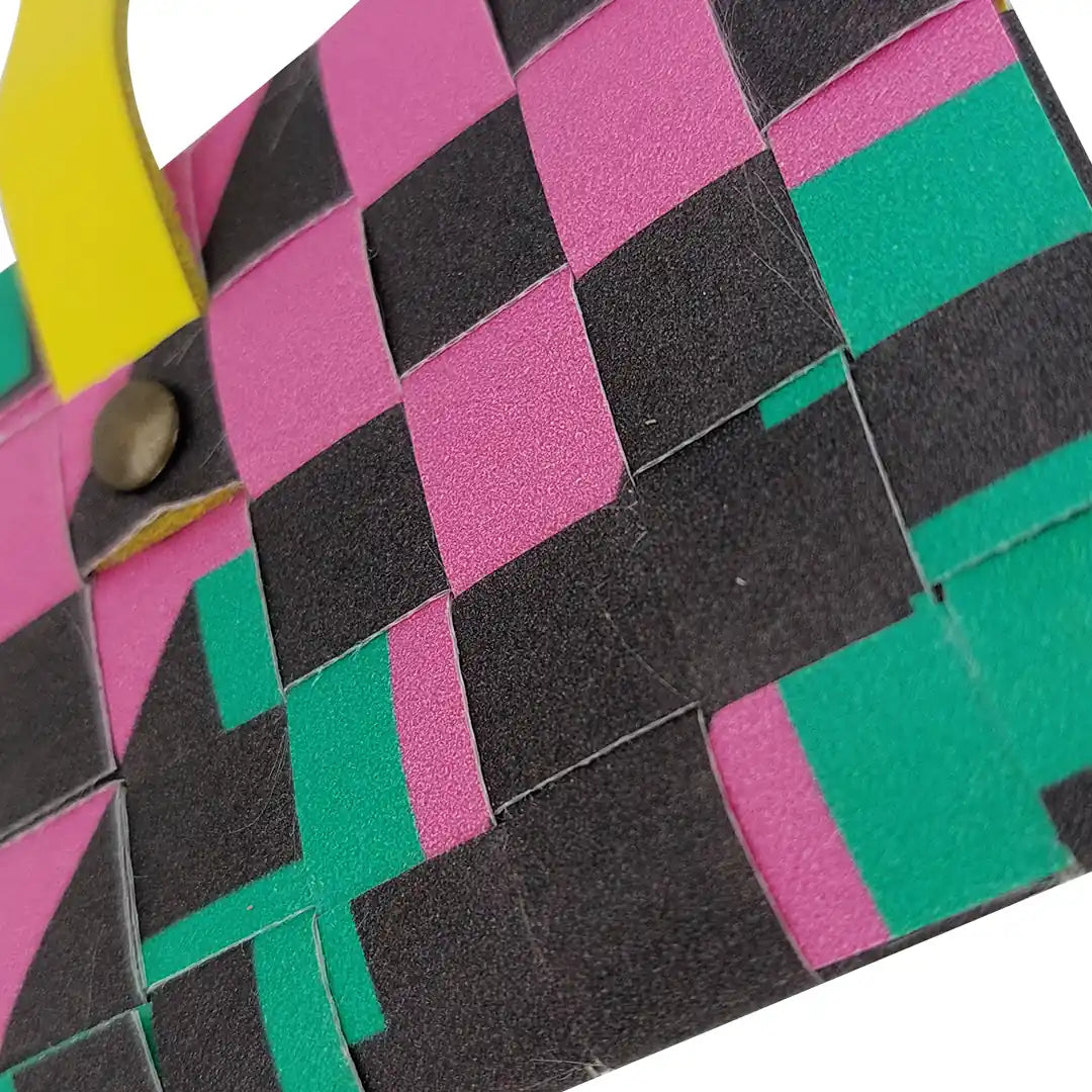 Sam Wallet 725 is a compact ReCreate wallet made from reclaimed advertising banner, with dark tones, vivid colour blocks and woven detail. - detail
